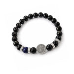 Pulsera elástica para hombre con esferas de piedra natural turmalina negra de 8 mm, hilo de silicona y medalla de San Benito en plata 925.