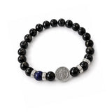 Pulsera elástica para hombre con esferas de piedra natural turmalina negra de 8 mm, hilo de silicona y medalla de San Benito en plata 925.