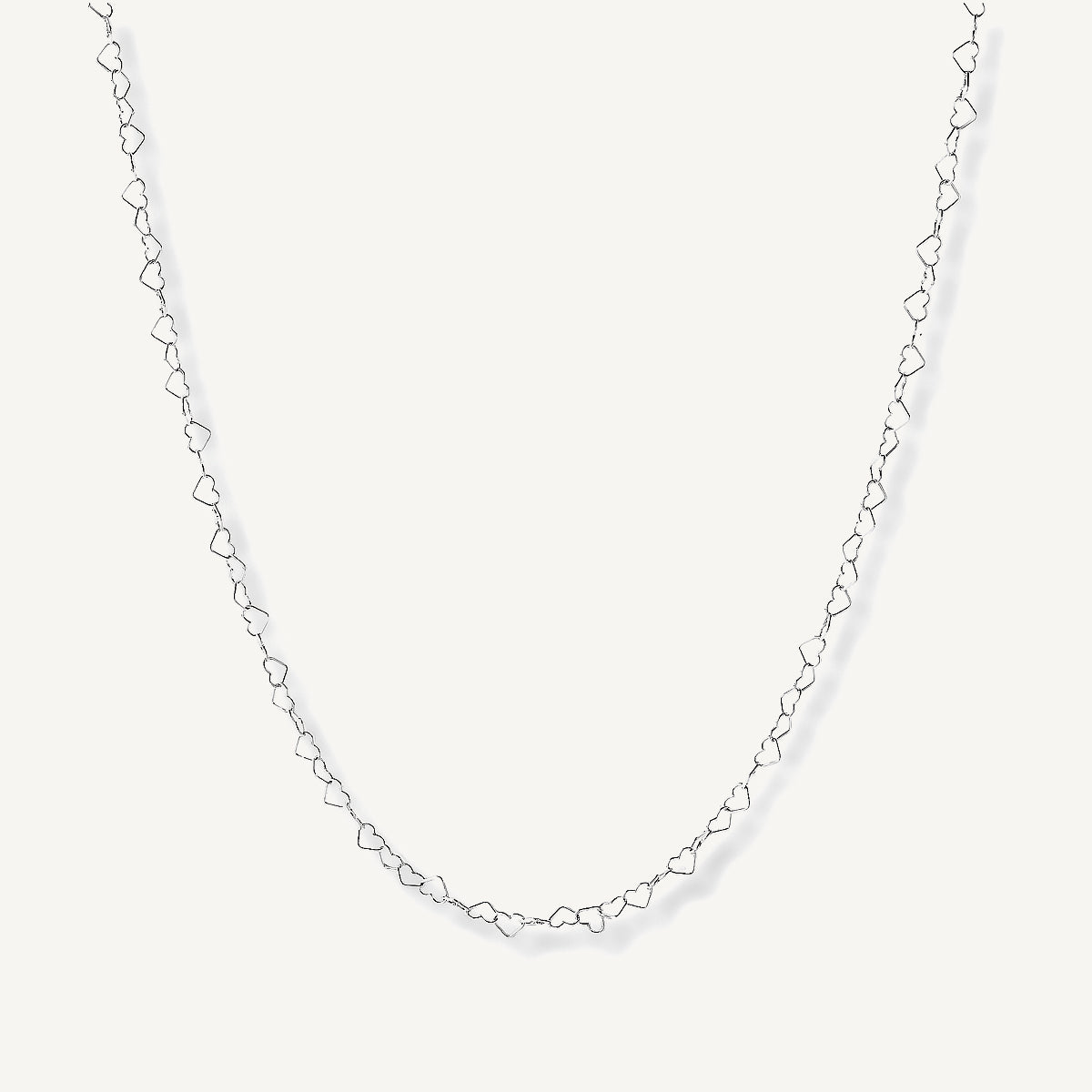 Collar de plata ley 925 con dije de dos corazones entrelazados con acabado liso y pulido.