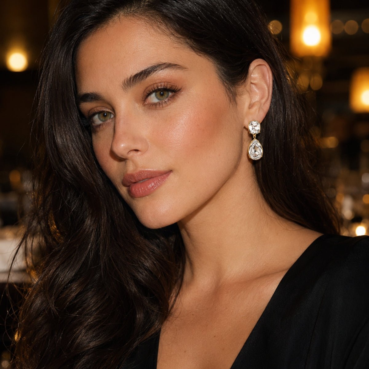 modelo con Aretes lexi candelabro color cristal enchapado en oro de 18K de AMBAR Joyería Fina