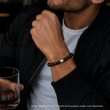 modelo con pulsera elástica para hombre modelo Orión con hilo de silicona, esferas de turmalina negra pulida y tubo cilíndrico central de plata 925.