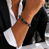 modelo con Pulsera Noir de ónix mate natural con piedras de 10 mm y 8 mm y accesorios de acero inoxidable para hombre.