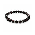 Pulsera elástica para hombre modelo Hermes con hilo de silicona, esferas de rodonita borgoña y tres aros texturizados de plata 925 sobre fondo blanco.