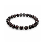 Pulsera elástica para hombre modelo Hermes con hilo de silicona, esferas de rodonita borgoña y tres aros texturizados de plata 925 sobre fondo blanco.