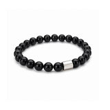 Pulsera elástica para hombre modelo Orión con hilo de silicona, esferas de turmalina negra pulida y tubo cilíndrico central de plata 925 sobre fondo blanco.